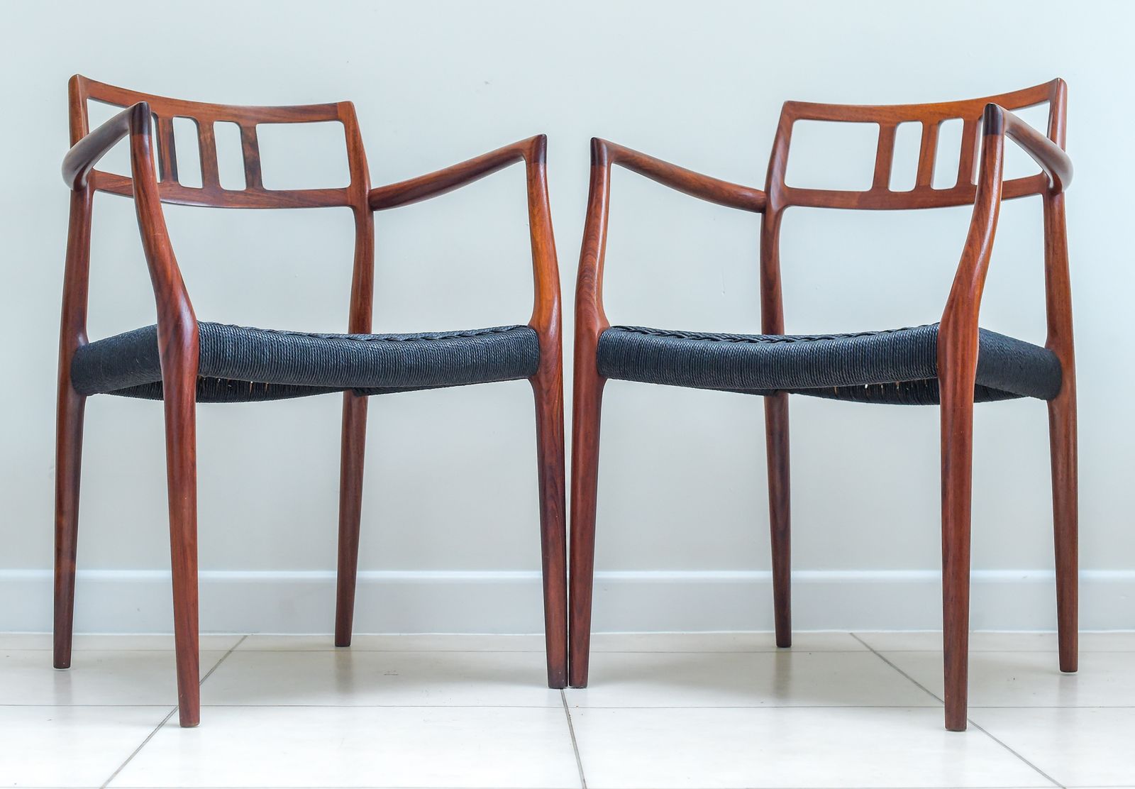A Scarce Pair Of Niels Møller Model 64 Rosewood Carver Chairs For J L Moller, Denmark.