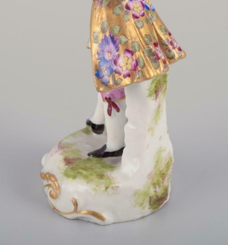 Meissen, Germany. Porcelain Figurine Of Young Man In Elegant Attire. photo vintage