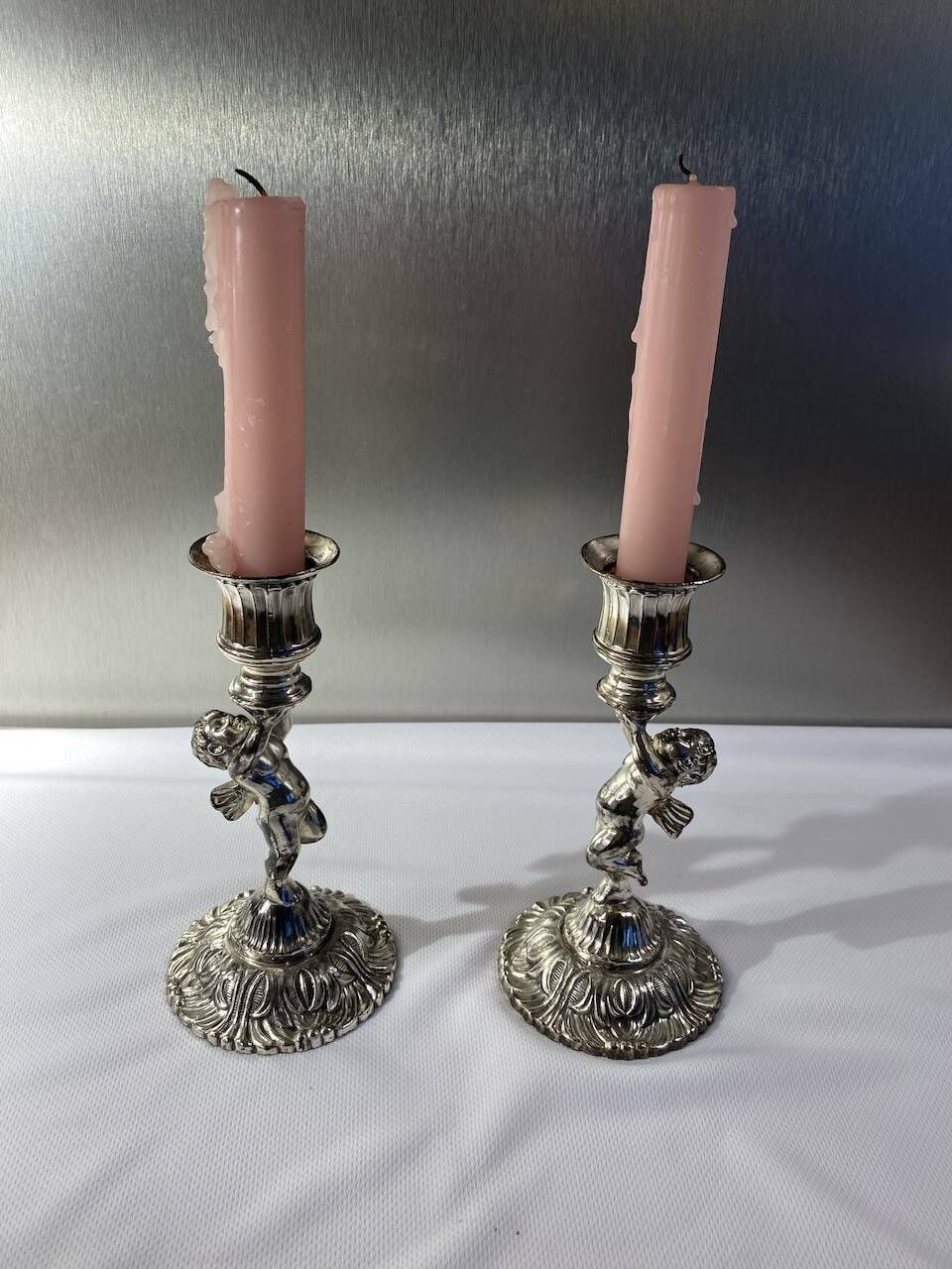 photo furniture Two Silver Metal Candlesticks Decorated With 20th Century Cherubs