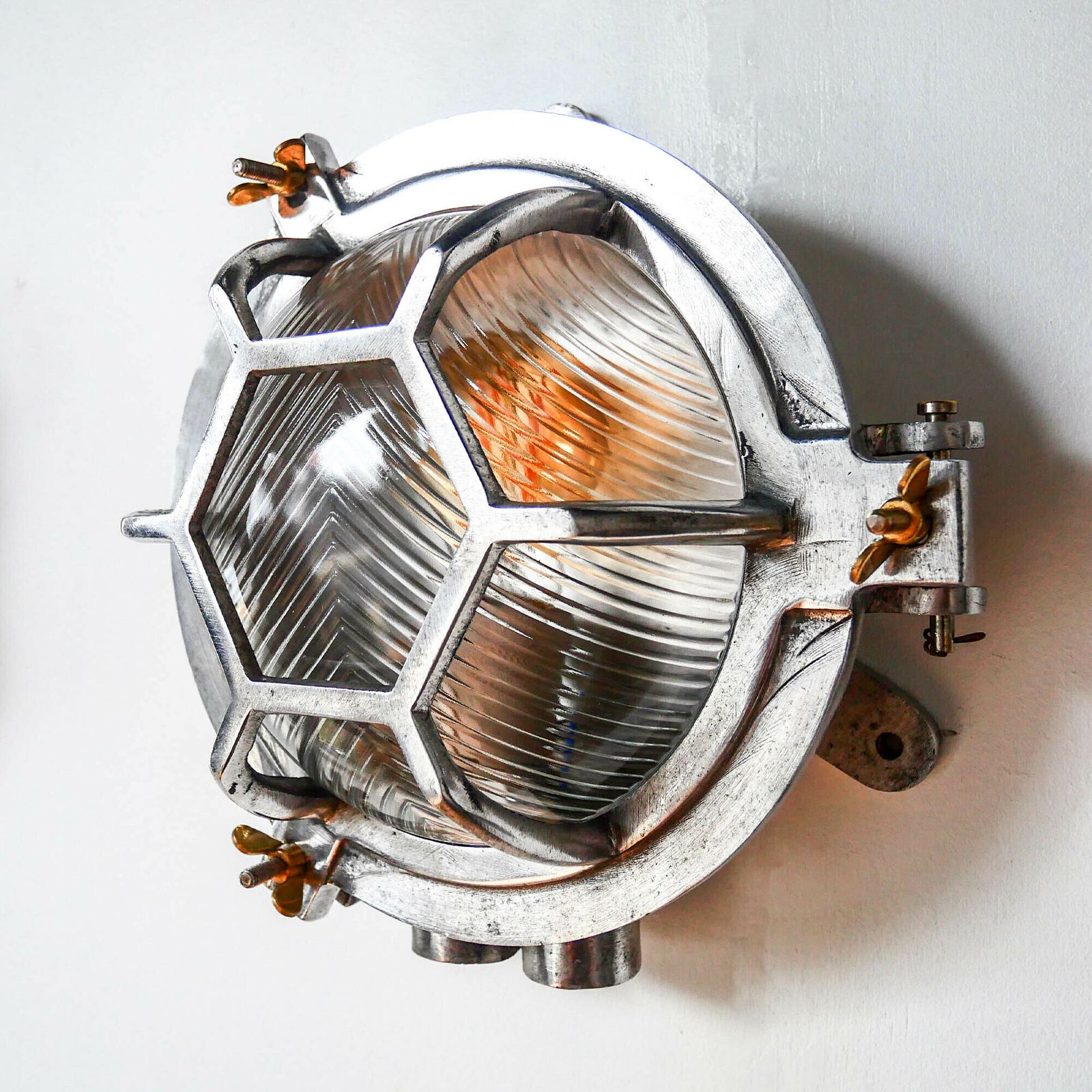 Old Cast Aluminum Wall Light With Hexagonal Grid And Wide Streaked Glass. photo for sale