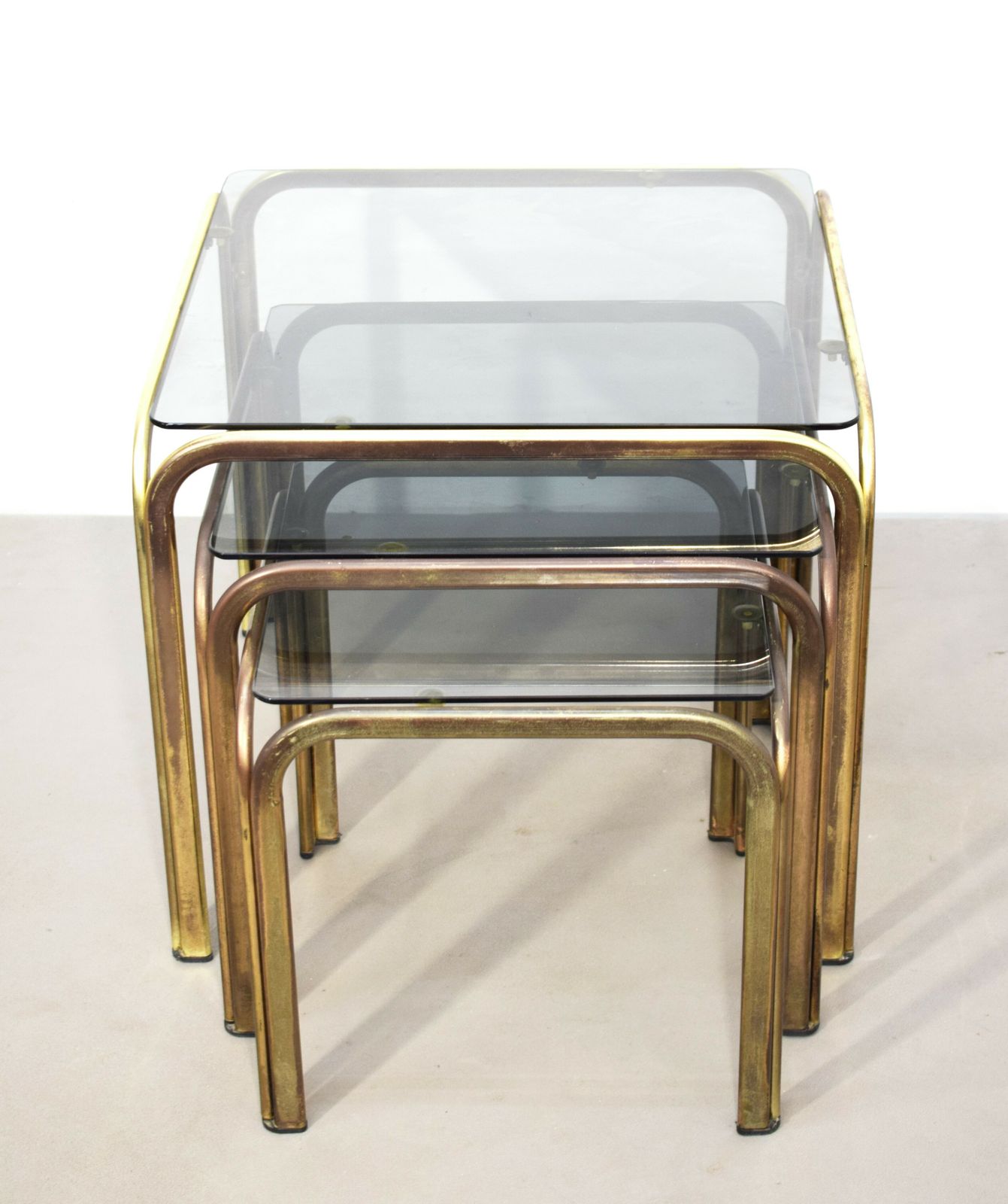 Set Of 3 Stackable Coffee Tables, Brass And Smoked Glass, 1970s.