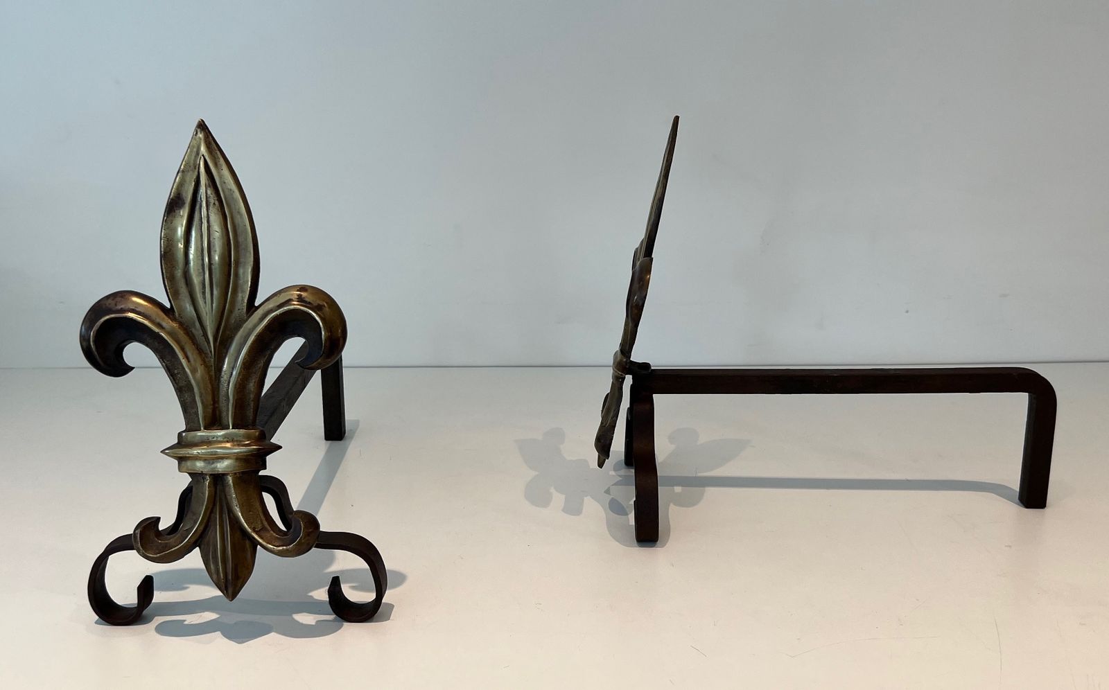 Pair Of Bronze And Wrought Iron Andirons Representing A Fleurs De Lys photo vinterior