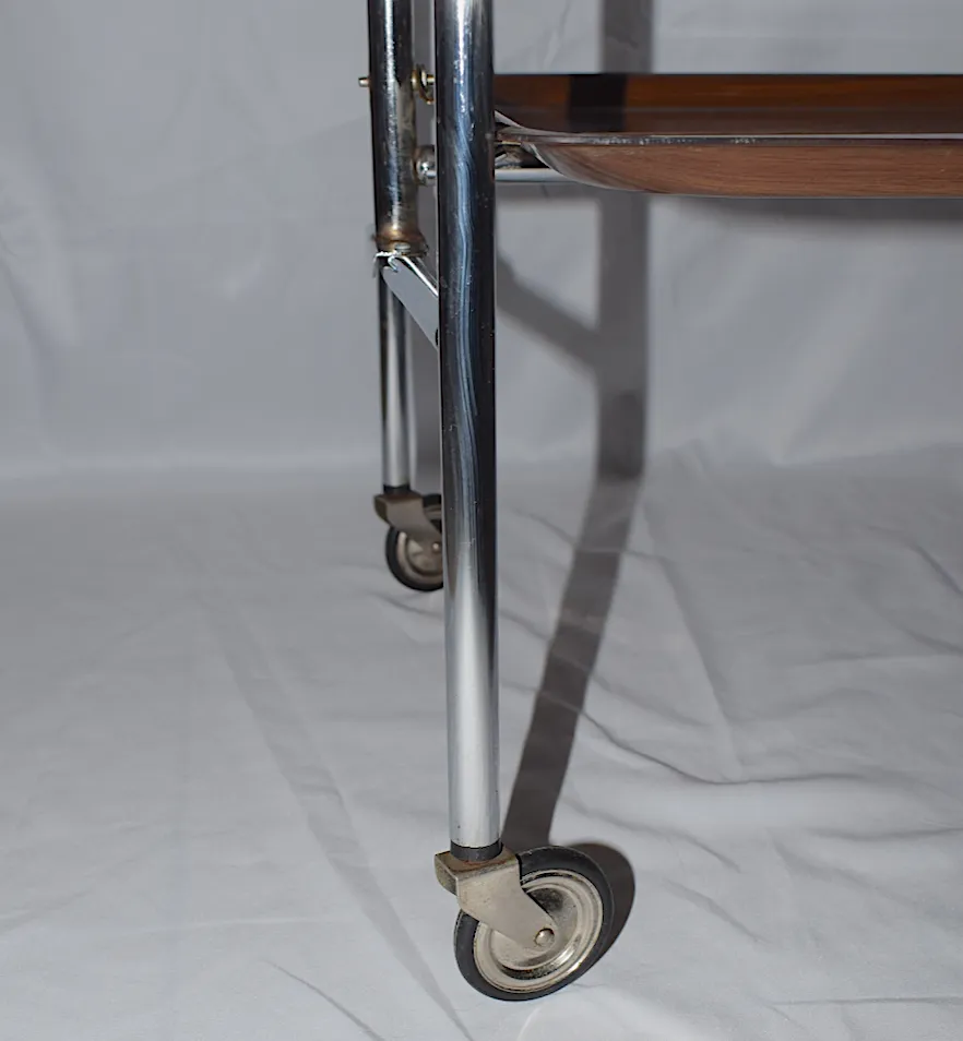 A Mid Century Bremshey & Co German Dinette Trolley. Made Of Chrome & Lamented Wood. It Folds Into A Smaller Frame. Attribution Mark On The Wheels. photo buy