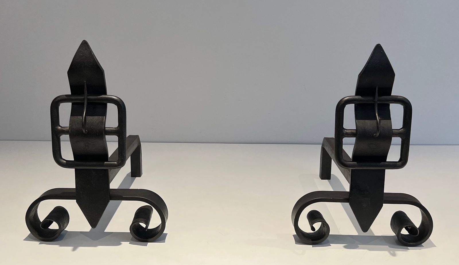 Pair Of Modernist Andirons Representing A Belt photo furniture