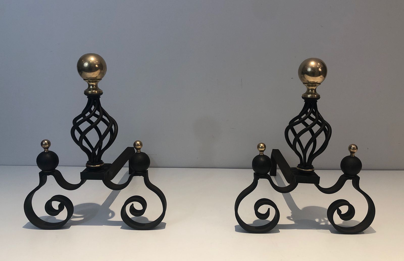 Pair Of Wrought Iron Andirons Topped With A Brass Ball