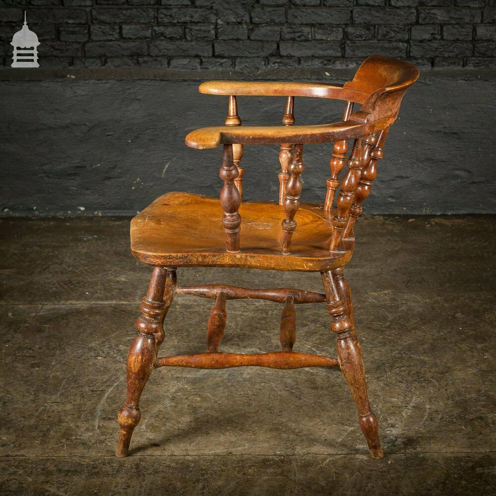 photo vintage 19th C Elm Captains Bow Seat Smokers Chair With Turned Arm Support And Double H Stretcher