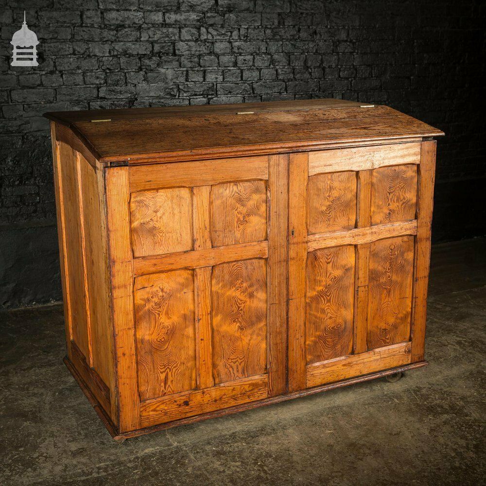 Large 19th C Figured Pitch Pine Ecclesiastical Cupboard With Double Doors, Opening Top And Metal Castors photo for sale