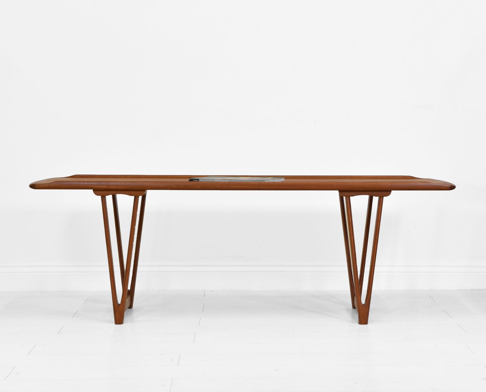 Mid Century Danish Teak Coffee Table On V Shape Supports And Lipped Top Edge photo for sale