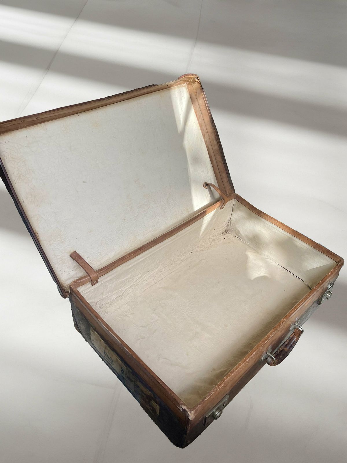 photo furniture Vintage/Antique Large Heavy Tan Leather Suitcase Stamped Army And Navy London With Stickers Circa 1930