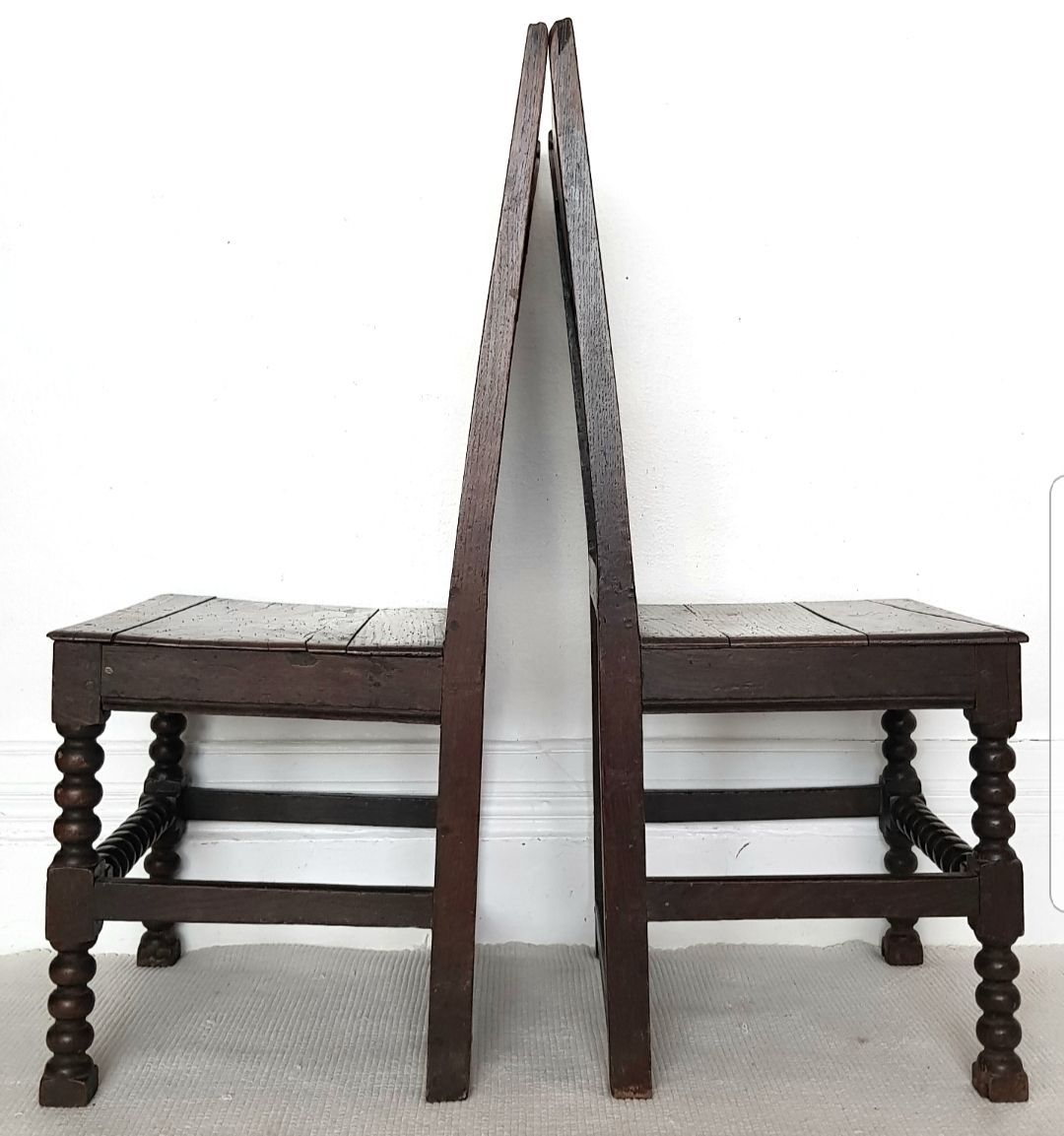 Furniture A Pair Of 16th Century Carved Oak Hall Chairs. photo