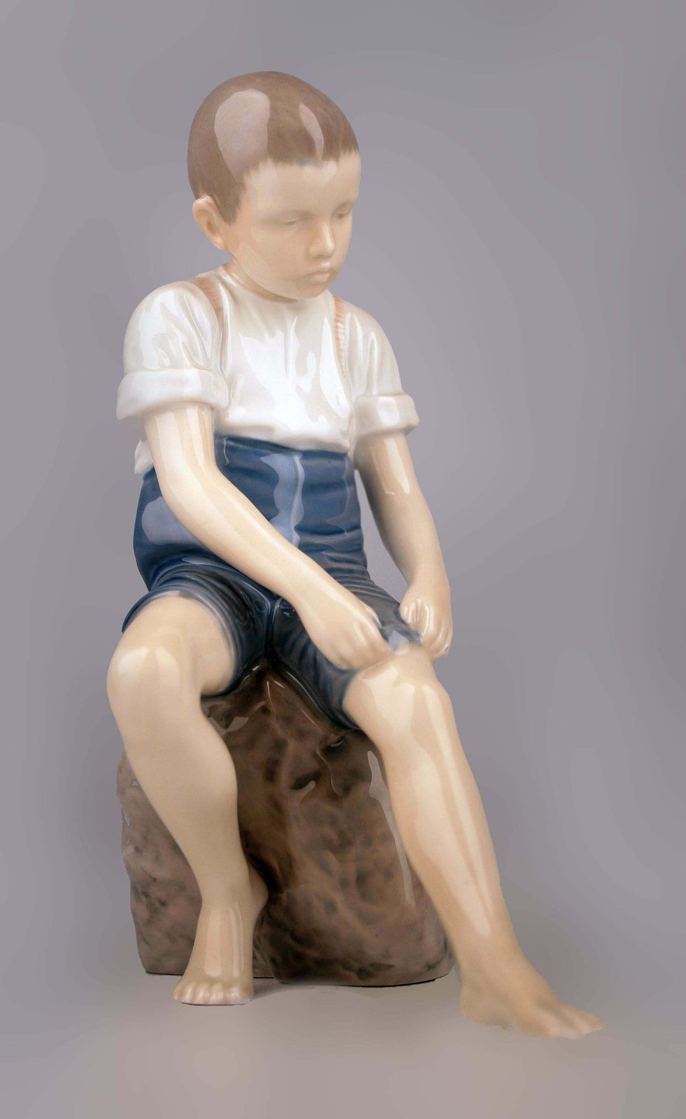 Mid 20th Century Scandinavian Modern Glazed Porcelain Sculpture Of A Boy Sitting On A Rock By Danish Company Bing & Grøndahl photo 500.0