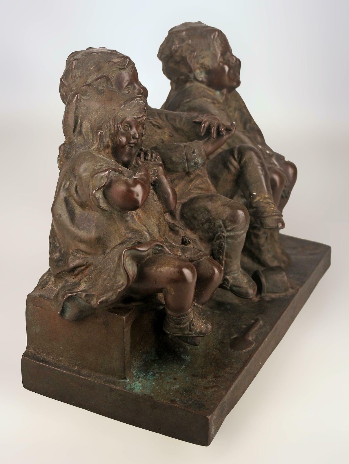 'Watching Something': Patinated Bronze Sculpture Of Three Children Laughing And Sitting By Spanish Artist Juan Clara photo Art