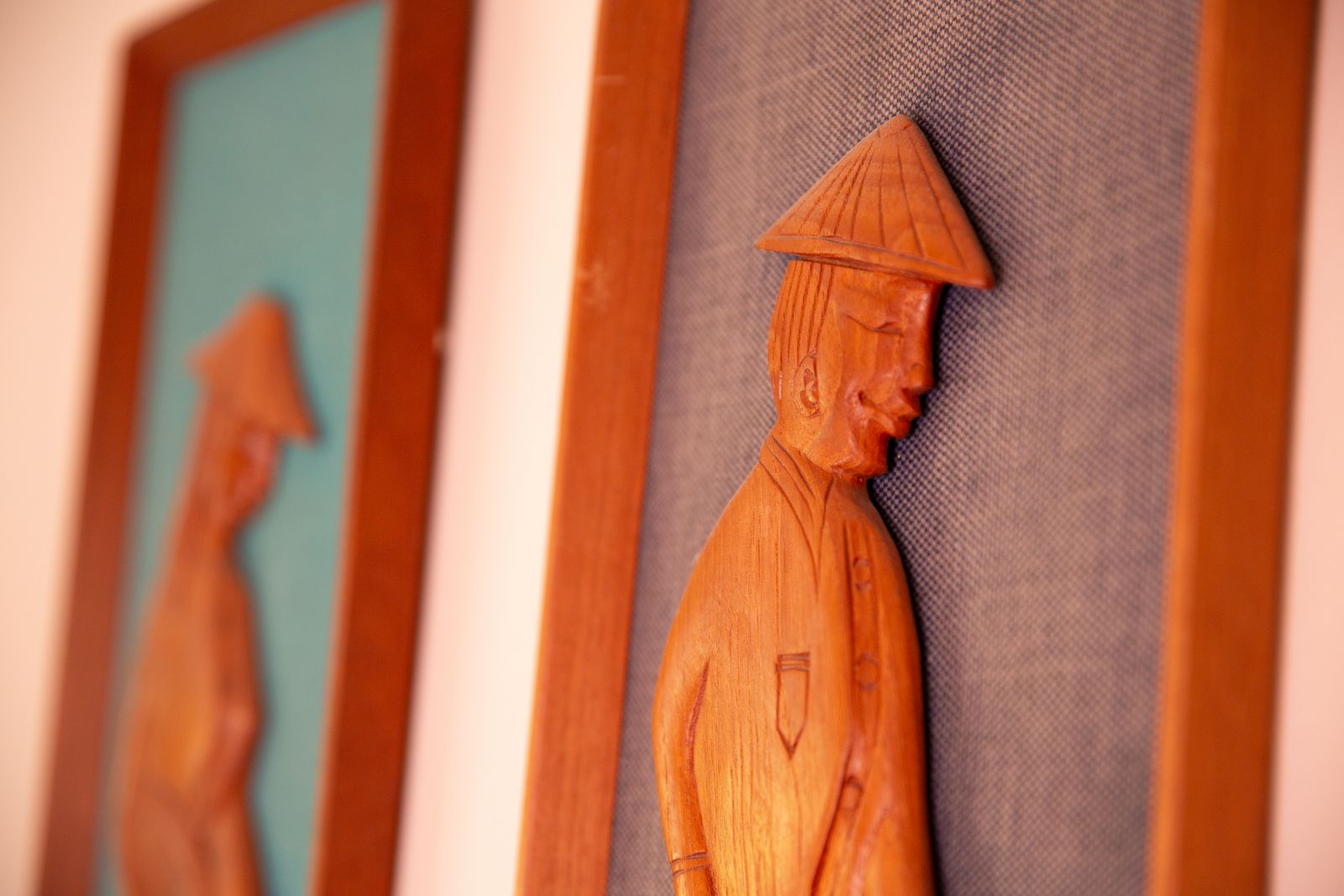 Pair Of Mid Century South East Asian Hardwood Wall Sculptures On Blue Canvas In Teak Frames photo vinterior