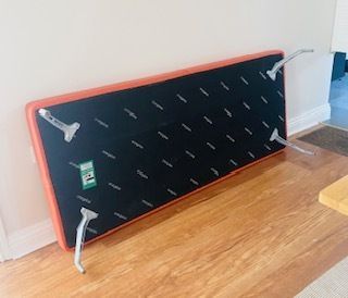 Mid Century Danish Style Long Bench. Orange Vinyl Upholstery And Stainless Steel Legs. Orangebox. photo 250.0