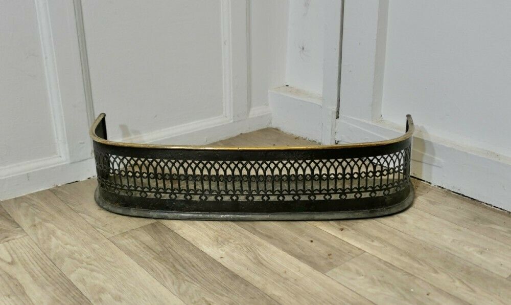 A Petite Victorian Pierced Brass And Iron Fender