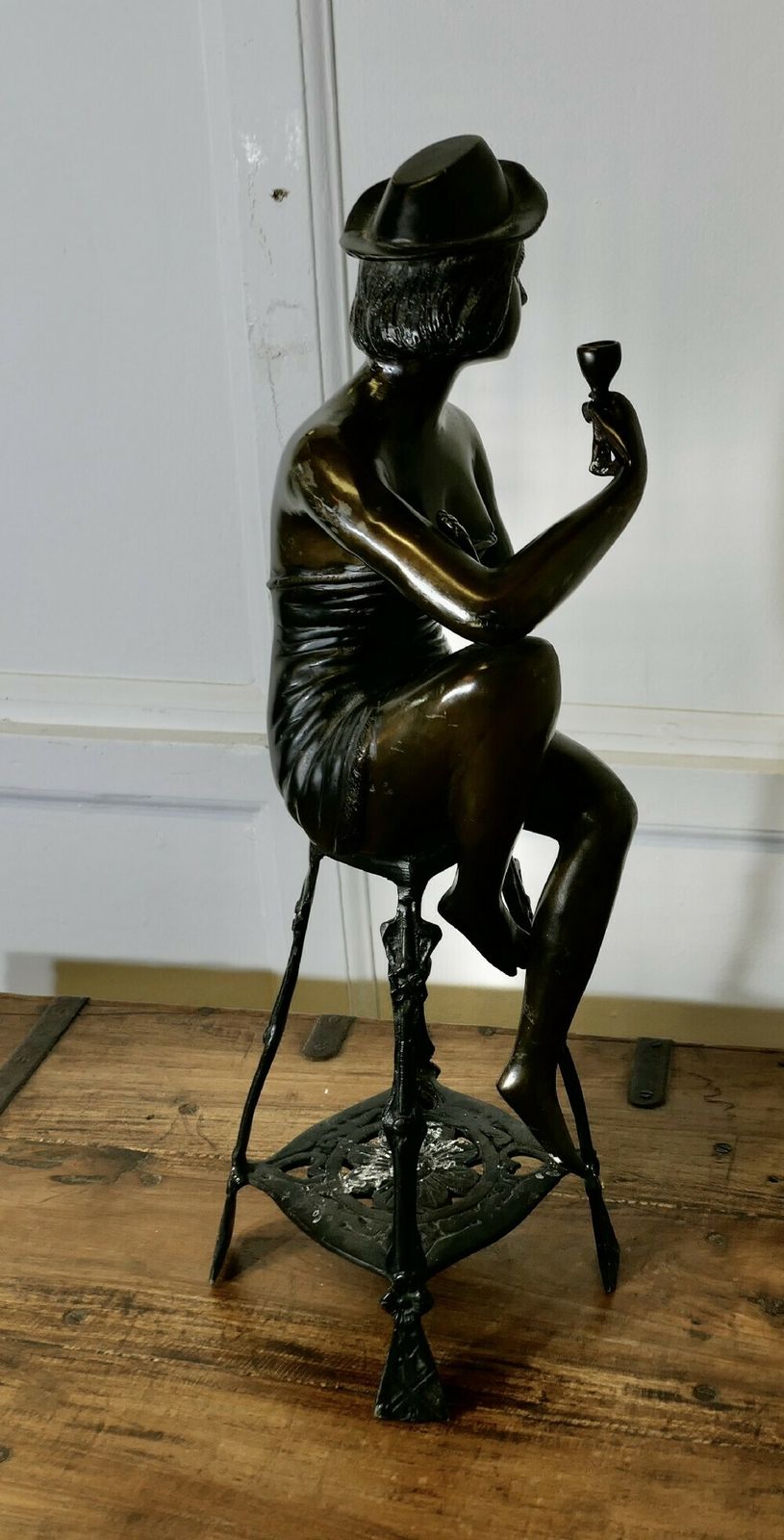 Bronze Statue Of A Girl On A Stool Drinking Champaign photo for sale
