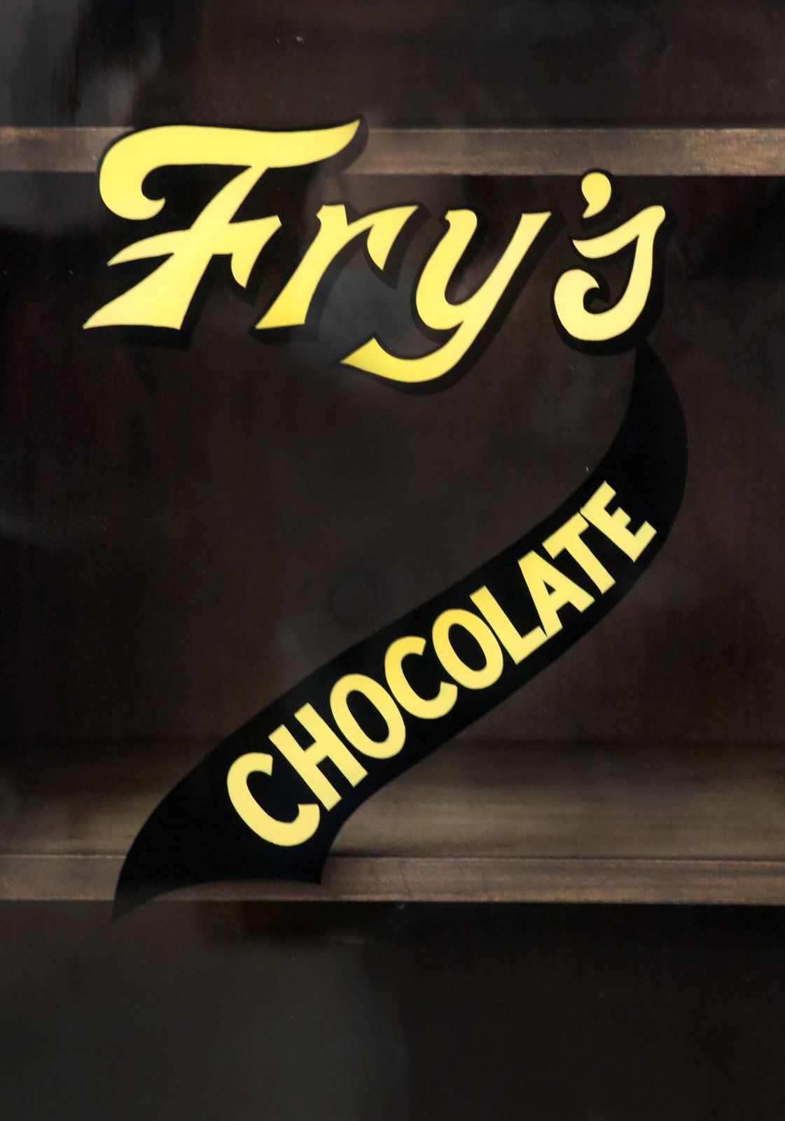 photo vintage A Wonderful Victorian American Walnut Glazed Cabinet, Later Hand Sign Written Advertising For Fry's Chocolate.