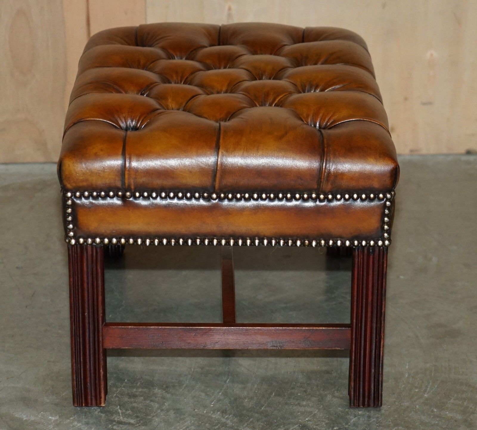 photo furniture Pair Of Fully Restored Vintage Hand Dyed Brown Leather Chesterfield Footstools