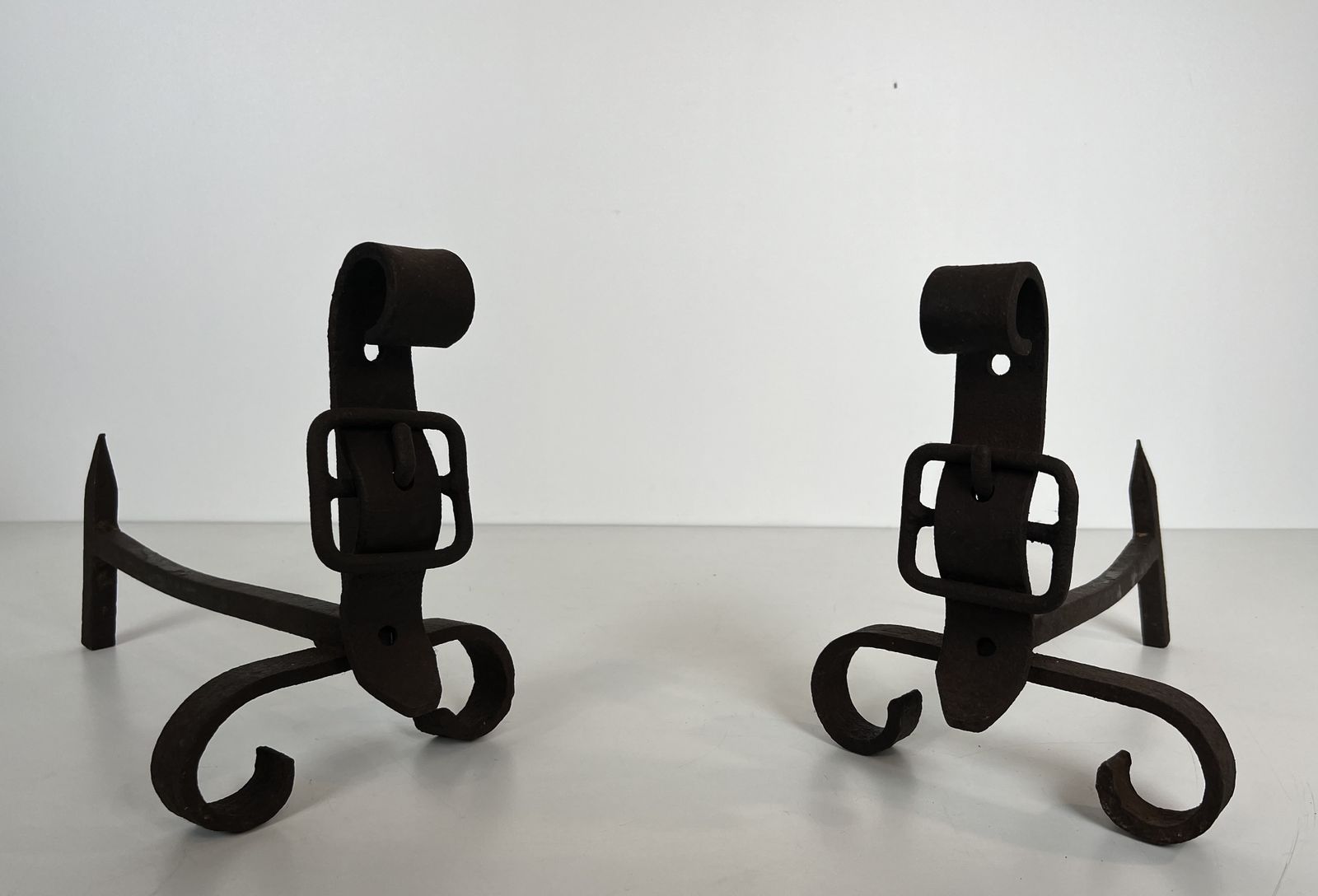 Pair Of Modernist Andirons Representing A Belt photo furniture