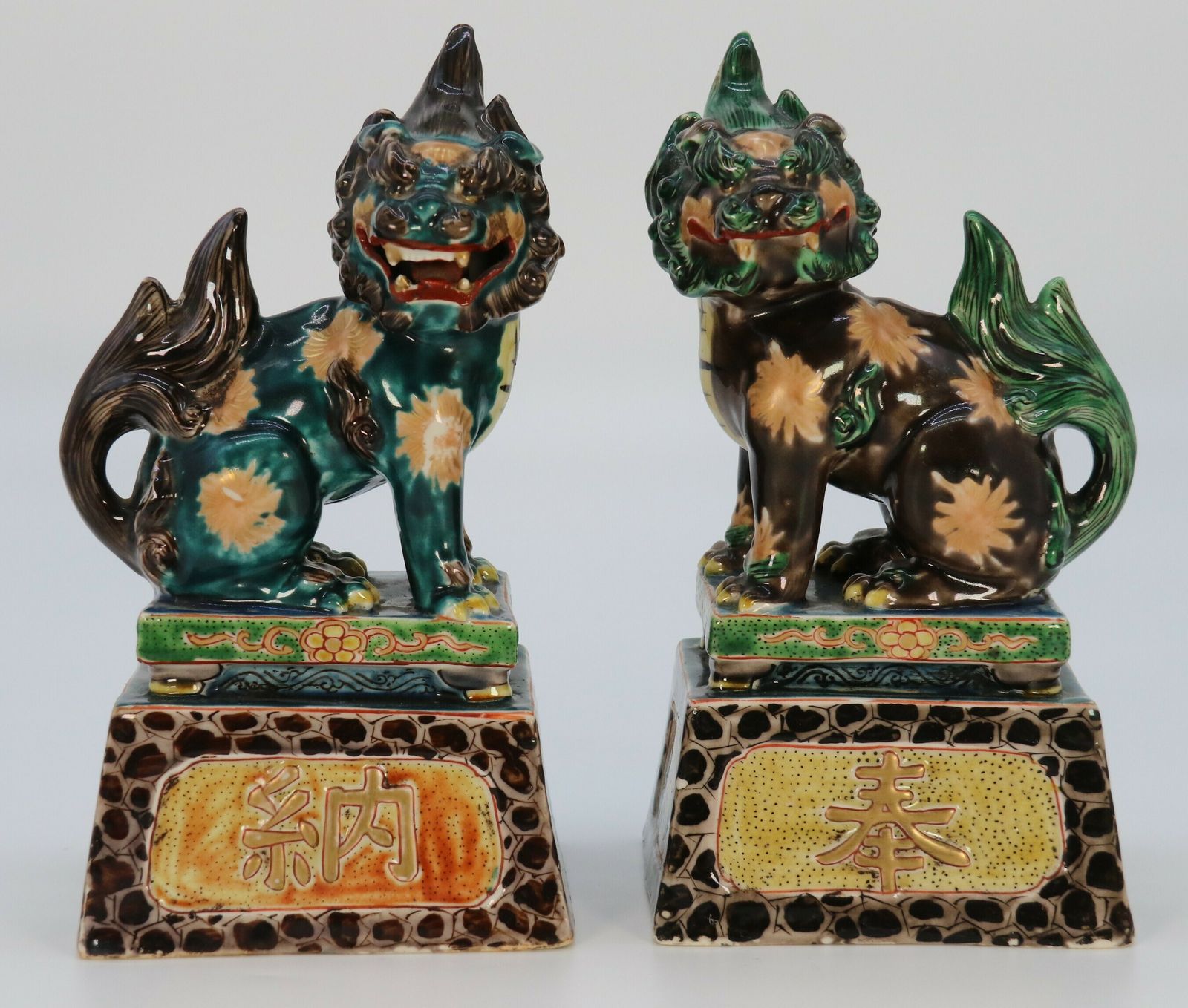 A Highly Decorative Pair Of Chinese Pottery Buddhist Lions Circa 1900.