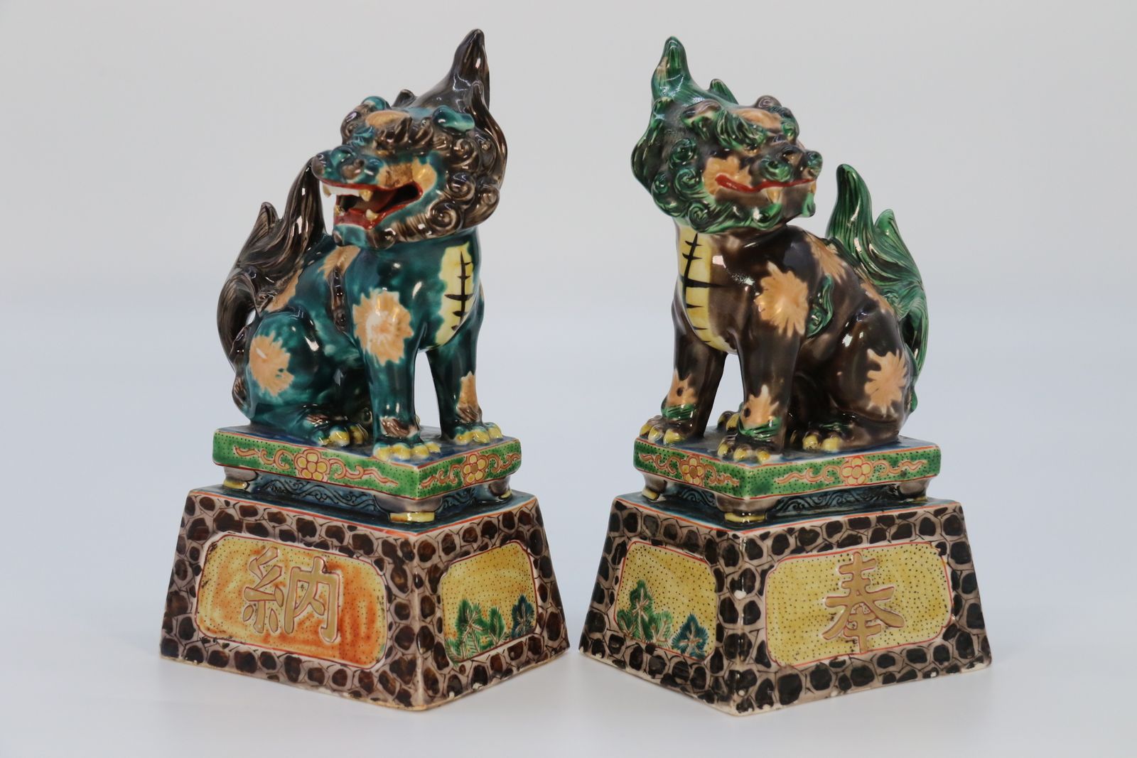 A Highly Decorative Pair Of Chinese Pottery Buddhist Lions Circa 1900. photo for sale