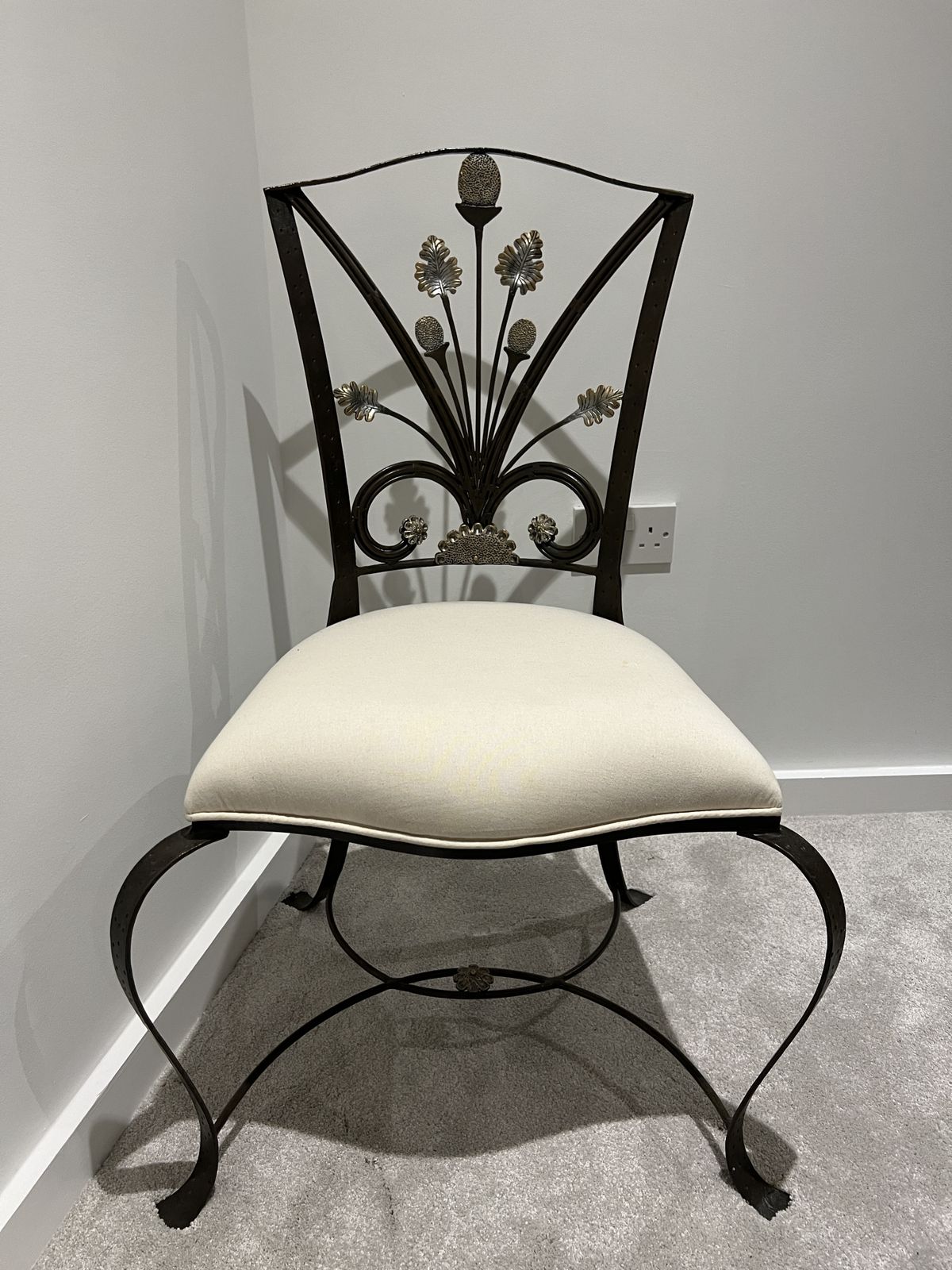 Elegant Black Wrought Iron Chair With Floral Backrest Design