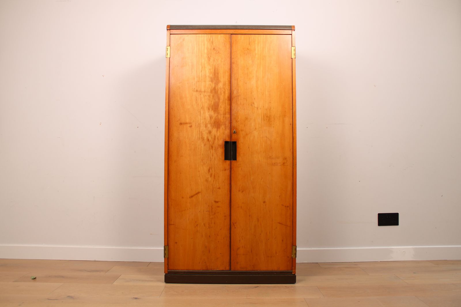 A Vintage Mid Century Cupboard, With Faux Leather Top And Recessed Metal Handles