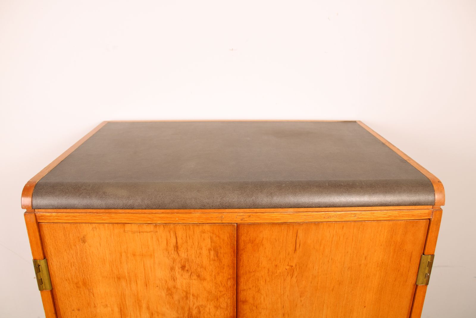 950.0 A Vintage Mid Century Cupboard, With Faux Leather Top And Recessed Metal Handles photo