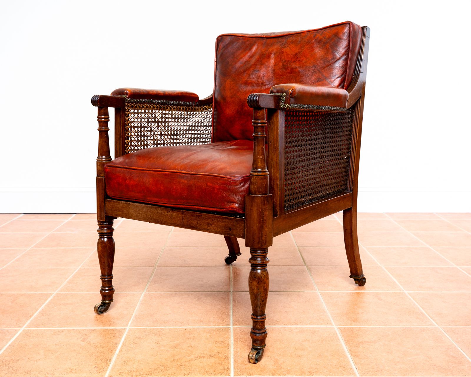 Fine Regency Bergere Leather Library Chair 1810 1820 Georgian Reading Red Leather Armchair Carved Cane Rattan Brass Castors photo furniture