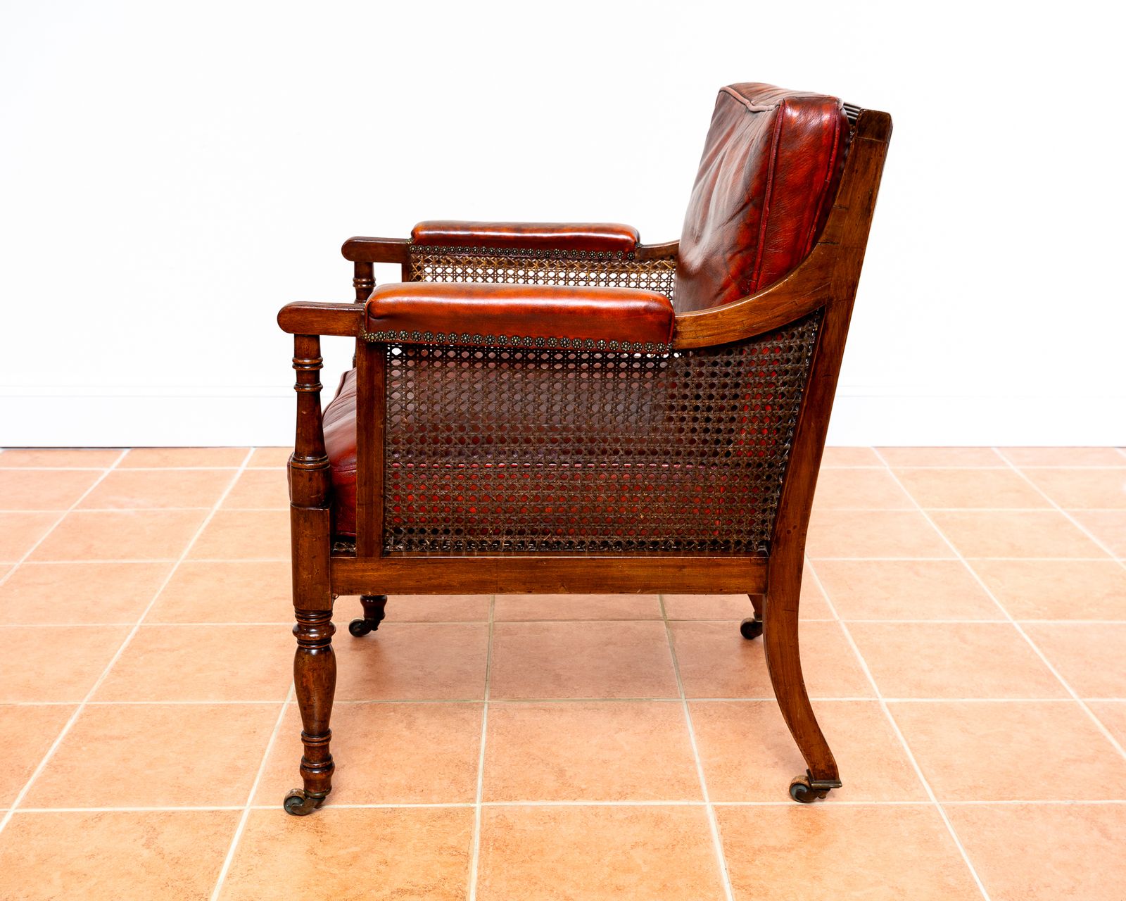 photo vinterior Fine Regency Bergere Leather Library Chair 1810 1820 Georgian Reading Red Leather Armchair Carved Cane Rattan Brass Castors