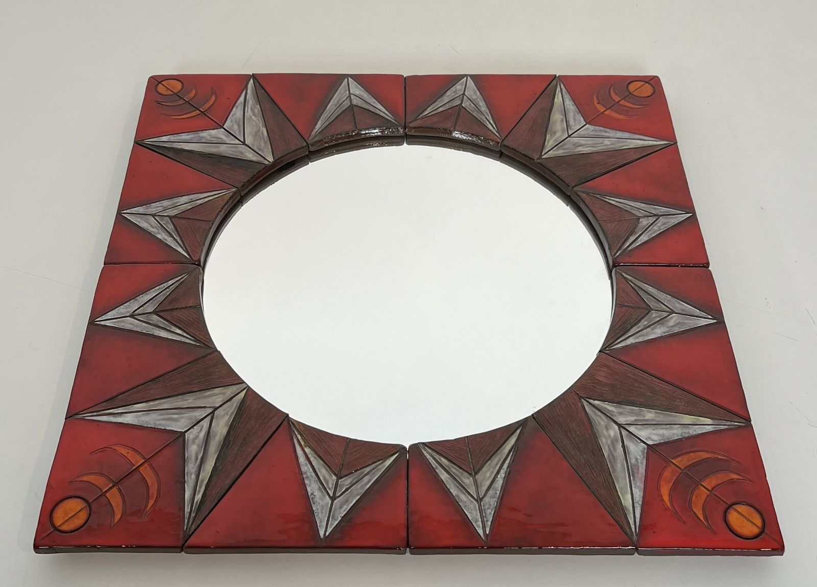 1450.0 Ceramic Mirror Depicting A Stylized Sun On A Red Background Attributed To Oswald Tiberghien photo