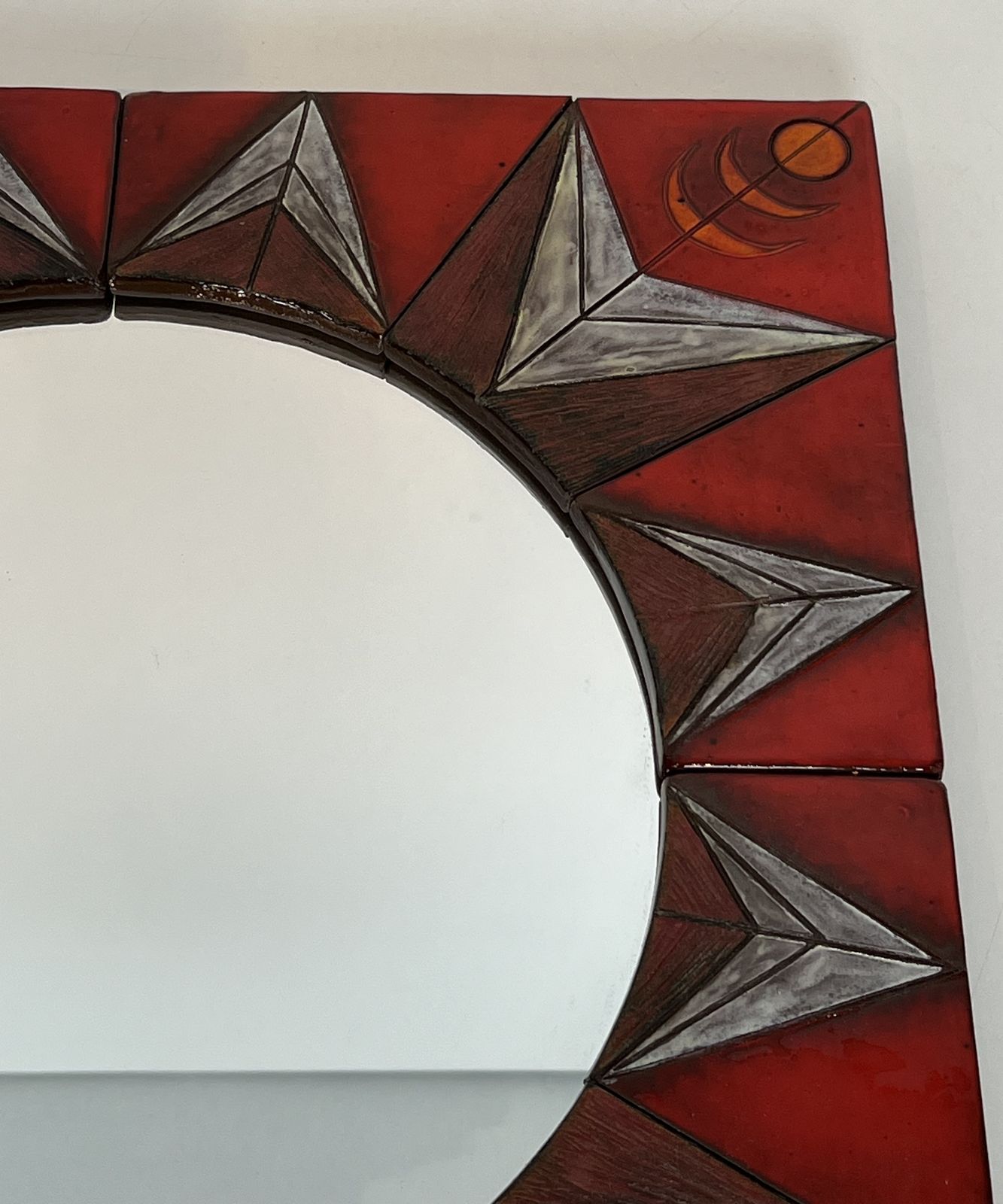 photo vintage Ceramic Mirror Depicting A Stylized Sun On A Red Background Attributed To Oswald Tiberghien