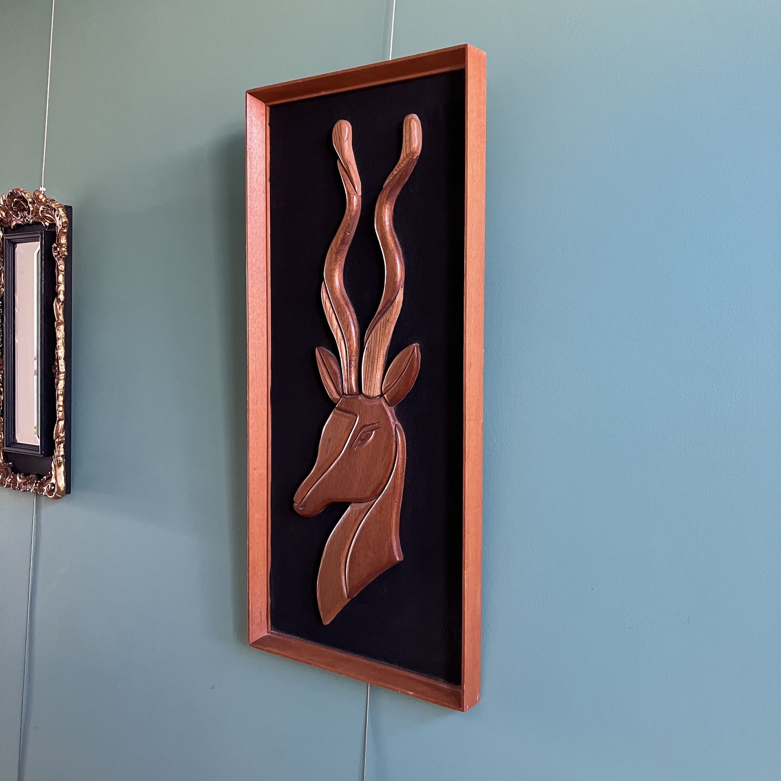 A Mid Century Teak Picture Of A Deer In A Teak Frame On Black Background