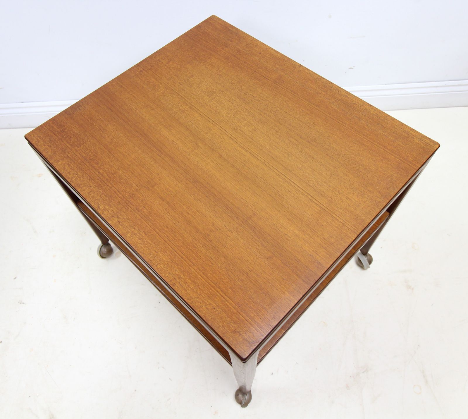 Mid Century Danish Style 2 Tier Teak Side Table On Castors photo for sale