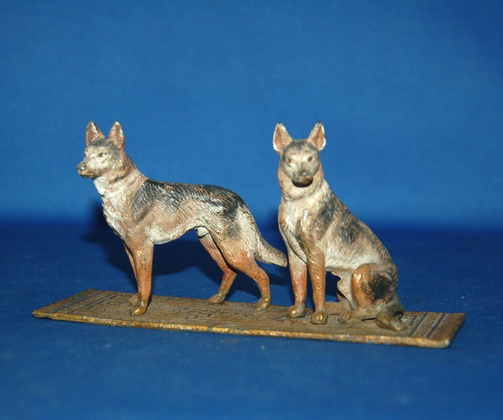 An Antique Cold Painted Cast Metal Alsatian Dog Pair On Carpet