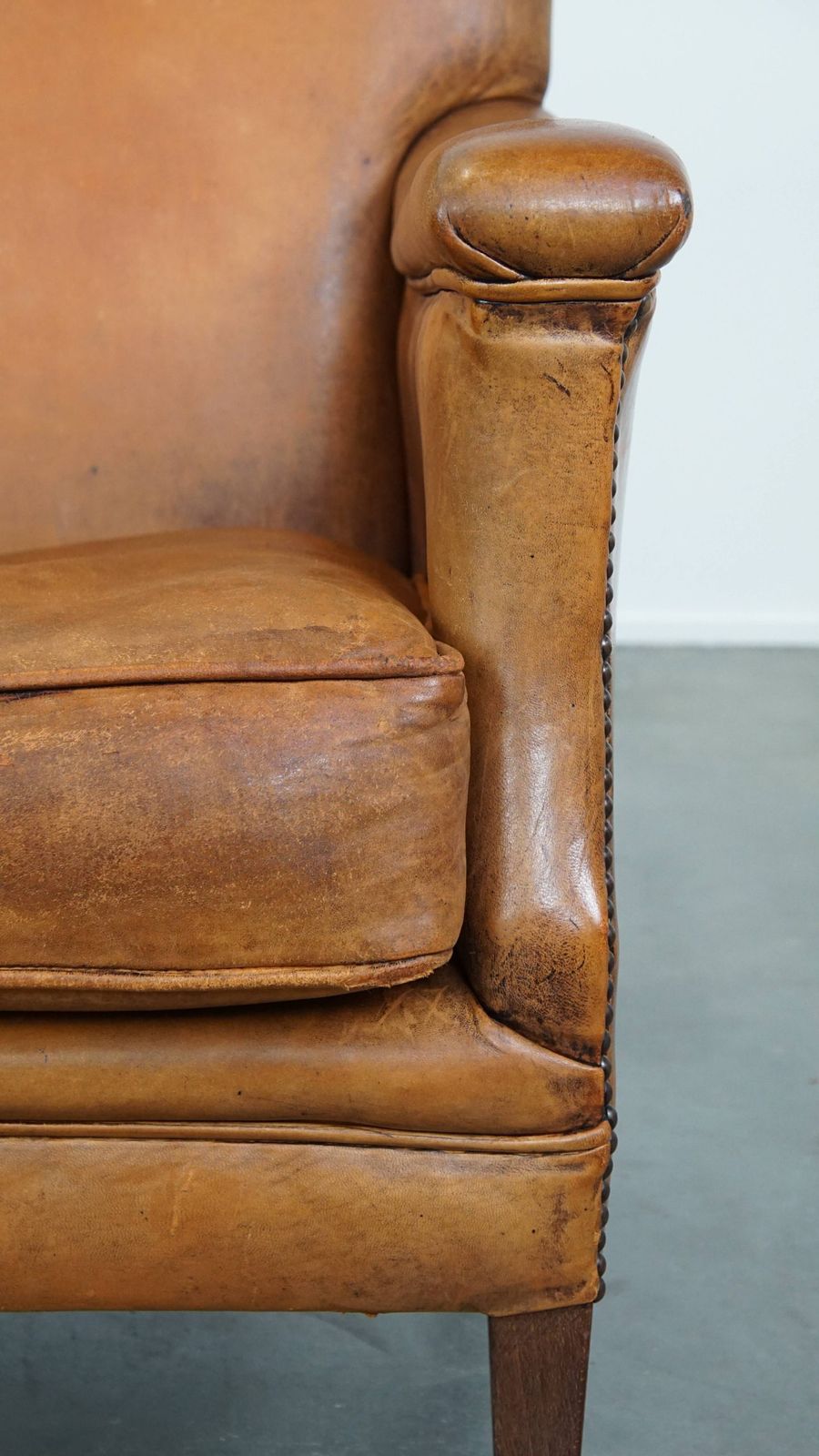 photo furniture Characteristic And Comfortable Cognac Colored Sheepskin Armchair With Straight Shapes And A Beautiful Patina
