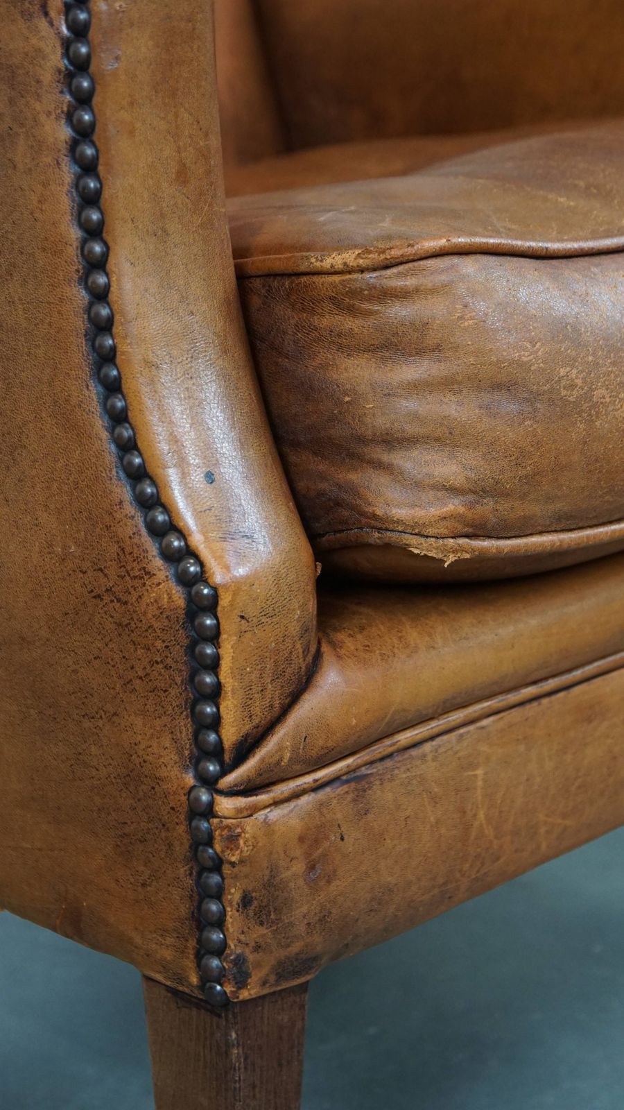photo for sale Characteristic And Comfortable Cognac Colored Sheepskin Armchair With Straight Shapes And A Beautiful Patina