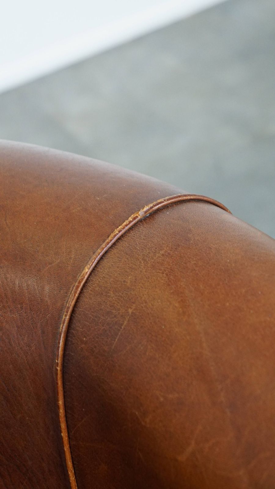 photo for sale Sheepskin Club Chair In A Charming Cognac Colour And Finished With Piping On The Backrest