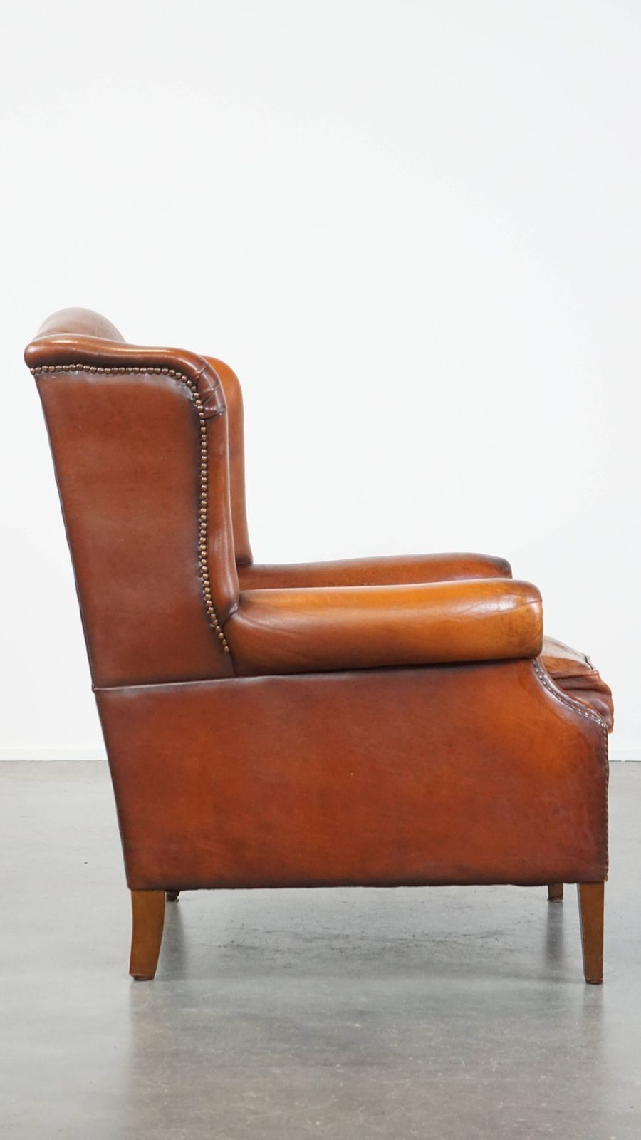 Comfortable Sheepskin Wing Chair With A Warm Color Scheme And A Beautiful Patina photo for sale