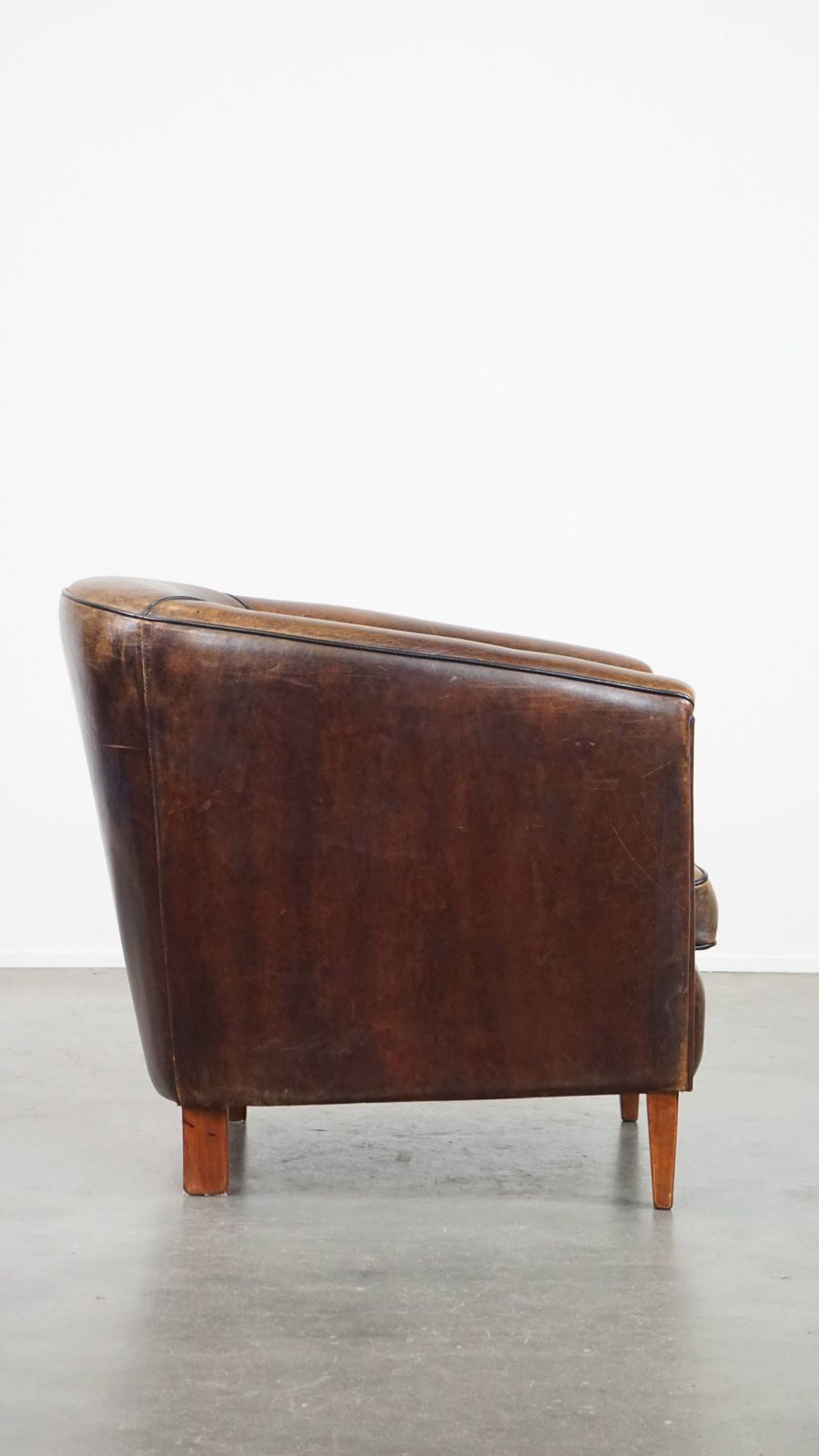 Dark And Sleek, Luxurious Sheepskin Club Chair With Beautiful Colours And A Black Piping Finish photo for sale