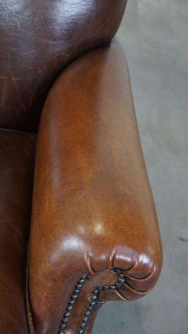 Klassieke Schapenvacht Fauteuil In Donkere Kleur, Goede Staat, Met Ronde Vormen En Op Wieltjes photo buy