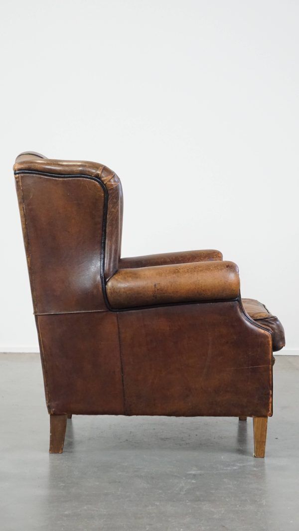 Characteristic And Comfortable Sheepskin Wing Chair With A Beautiful Patina photo for sale