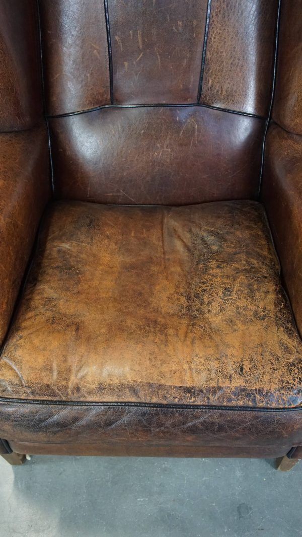 Characteristic And Comfortable Sheepskin Wing Chair With A Beautiful Patina photo vinterior