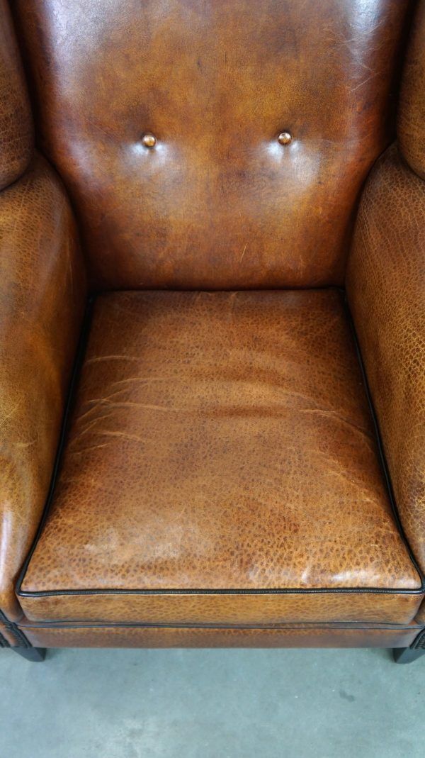Beautiful Armchair Made Of Very Good Quality Sheepskin Finished With Nails And Black Piping photo vintage