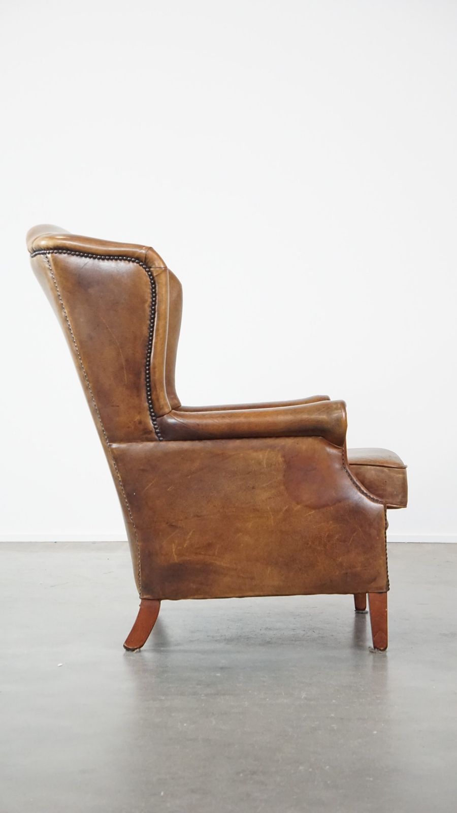 Charming Sheepskin Wing Chair With A Beautiful Patina And Good Seating Comfort photo for sale