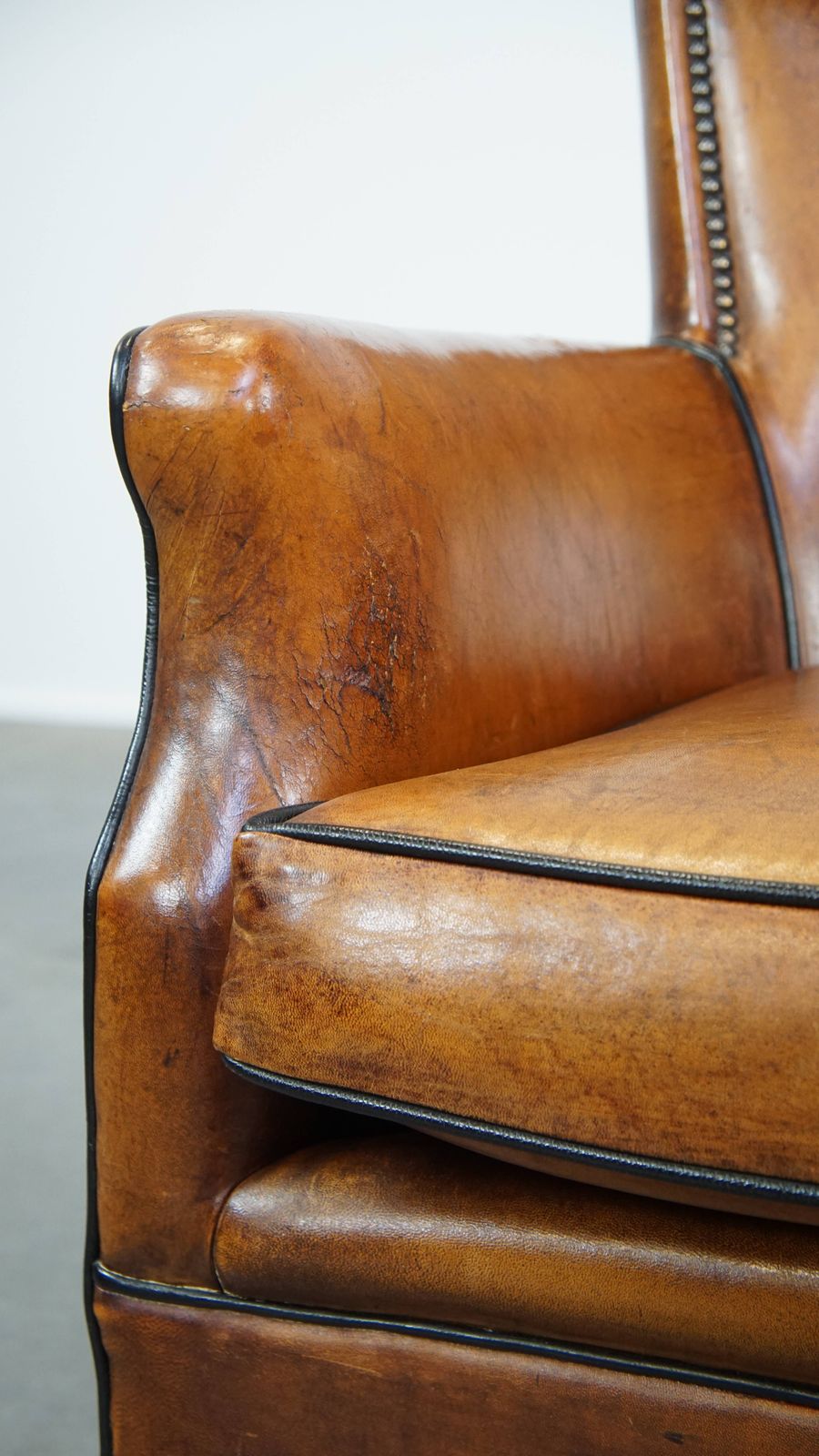 Furniture Subtle Cognac Colored Sheepskin Armchair With A Nice Design And Finish With Black Piping And Decorative Nails photo