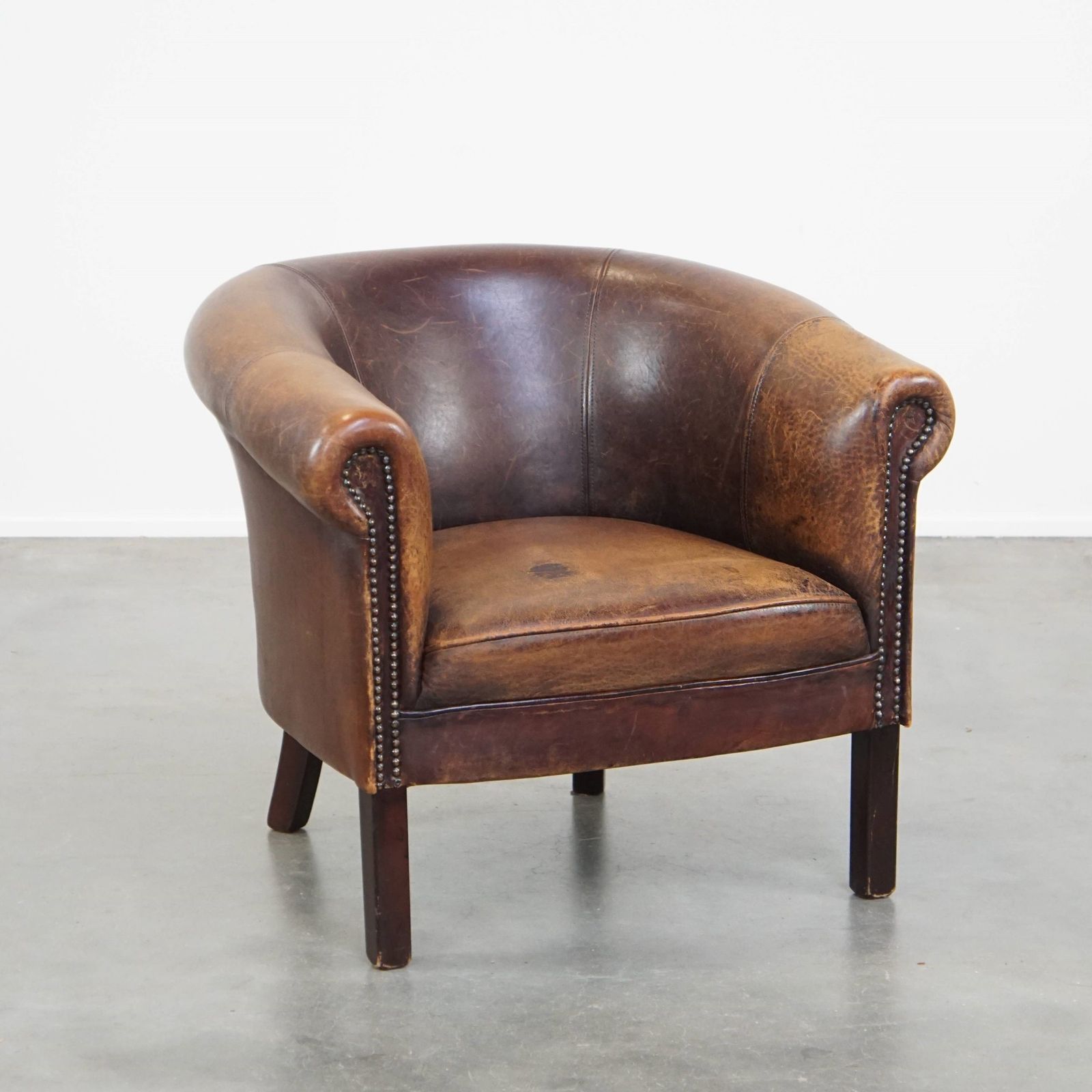 Subtle Sheepskin Club Chair With A Robust Appearance And Neatly Finished With Decorative Nails