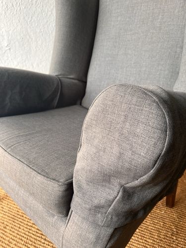 Large Comfortable Antique Wingback Chair With Clean Grey Coloured Loose Covers photo Furniture