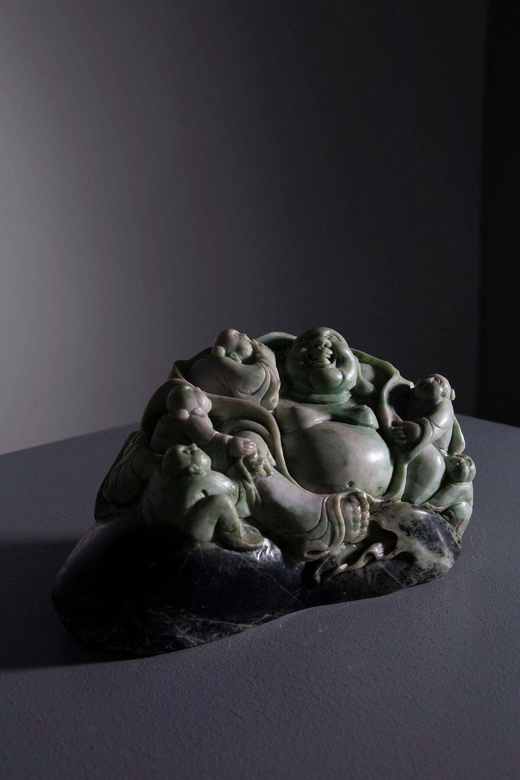 Sculpture Of Buddha Surrounded By Children In Jade Root photo buy