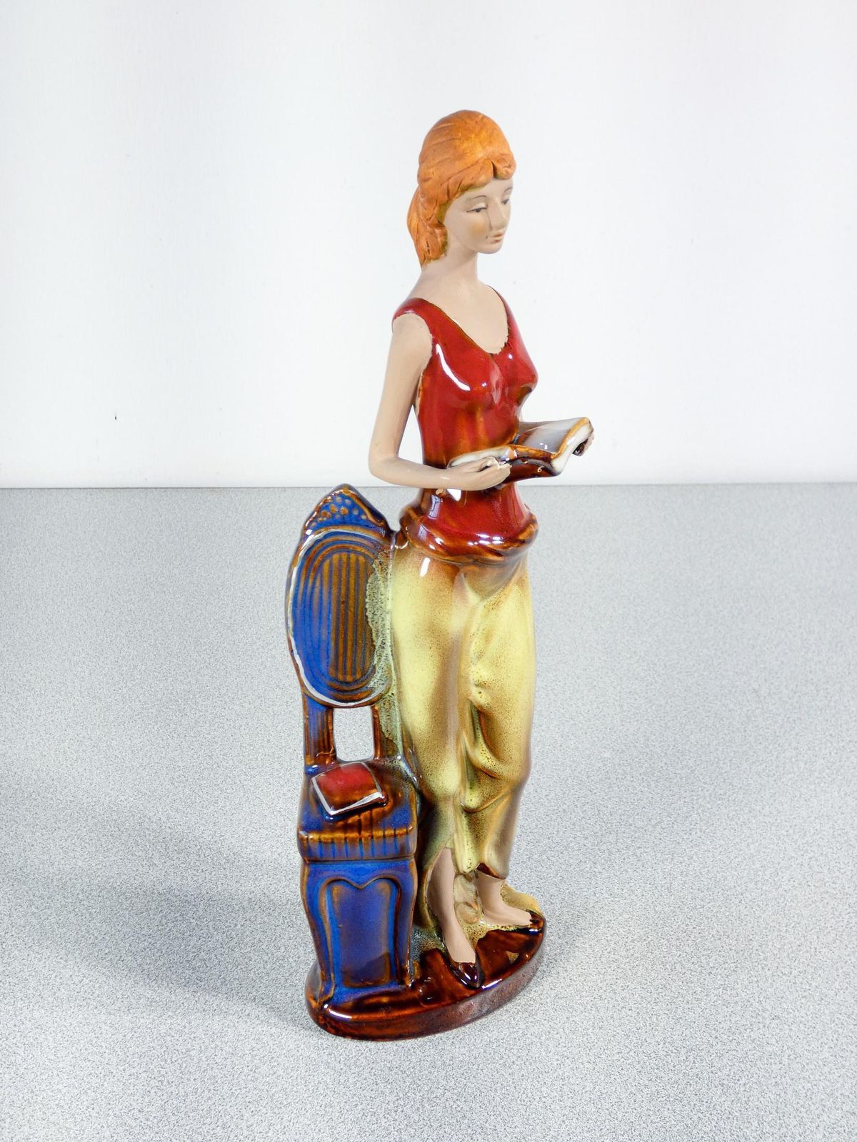 Painted And Glazed Ceramic Sculpture. Woman With Books. Italy photo Art